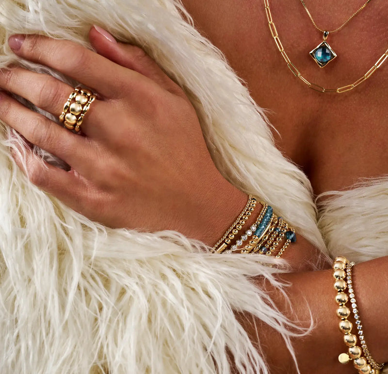 Goudgetinte kralenring met een gestapeld ontwerp met ronde, gepolijste kralen.